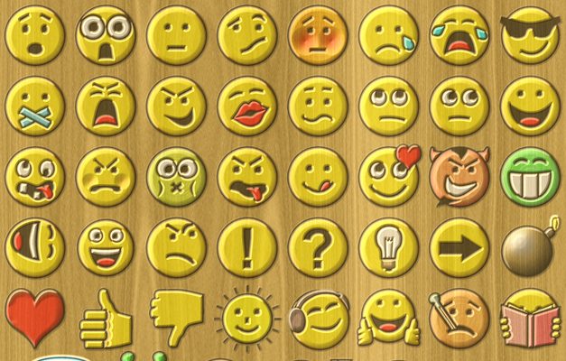 A generated wood-texture background shows 56 different emojis. Some show happy expressions, sad expressions, angry, crying, laughing and more. There are also non-expressive emojis, such as a thumbs-up image, thumbs down, a red heart, a green alien and more.