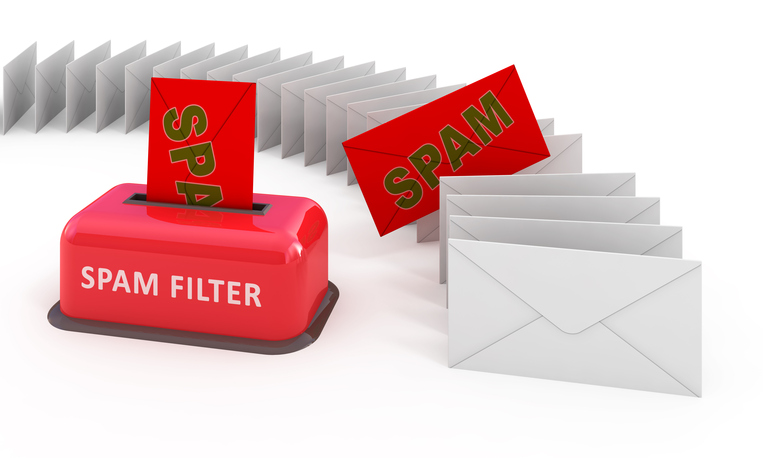 A computer-generated image shows a bright-red box with a slit on the top with a bright-red envelope sticking out. Written on the box in white is, “Spam Filter.” The red piece of mail has the word “Spam” on it, although the “m” is cutoff because it’s inside the slit. To the right is a row of white envelopes lined up like dominos and curving off to the left. One of those envelopes is bright-red and has “Spam” written on it in olive green.