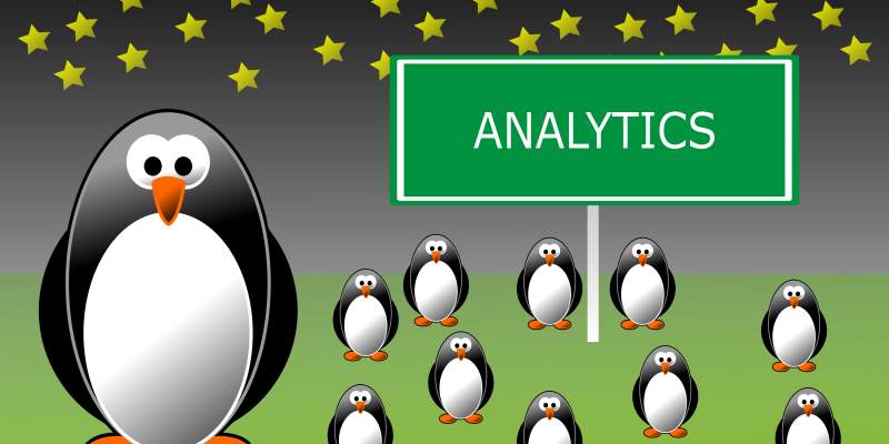 An illustration of penguins standing around a sign that reads Analytics.