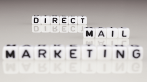 An image of dice that spell Direct Mail Marketing.