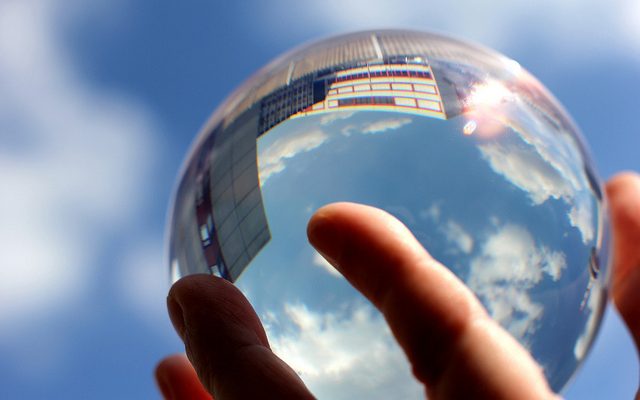 A hand holds a crystal ball.