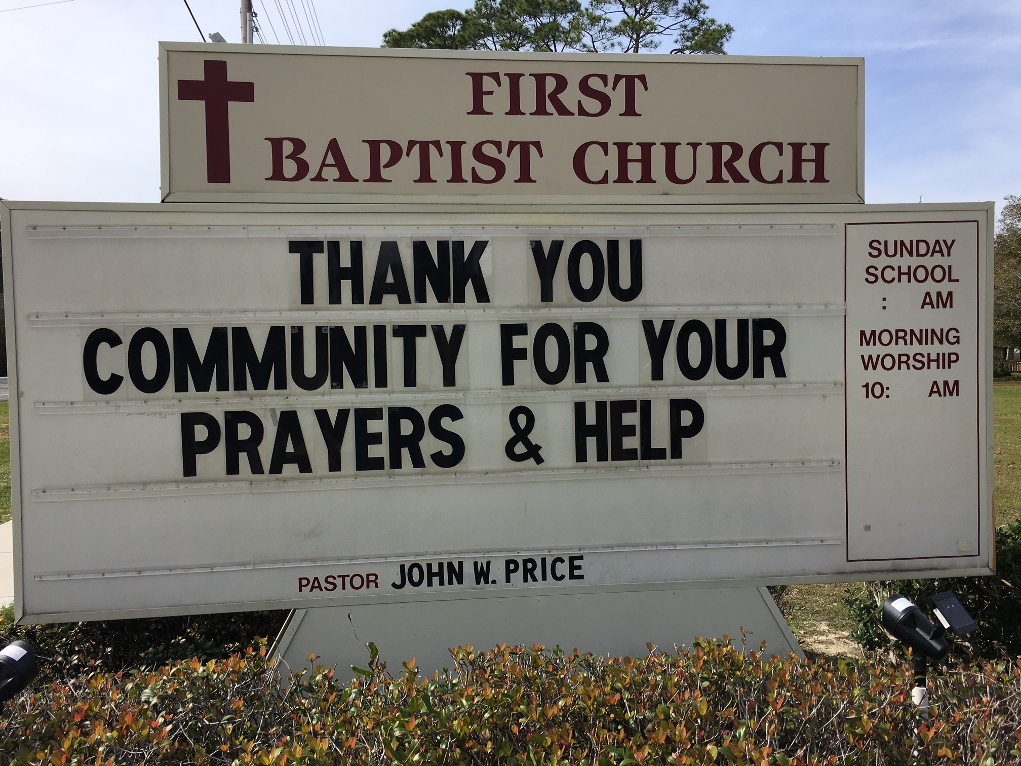 A white sign for First Baptist Church thanks the community for their prayers and help. 