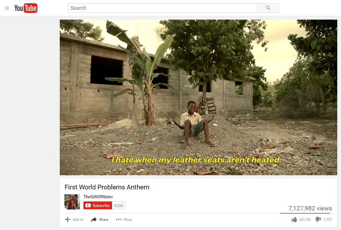 A screenshot of the YouTube video First World Problem Anthems shows a little boy sitting on a pile of rubble with the caption “I hate it when my leather seats aren’t heated”.