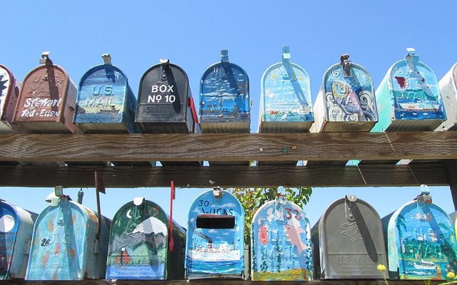 A shot of a row of different mailboxes.
