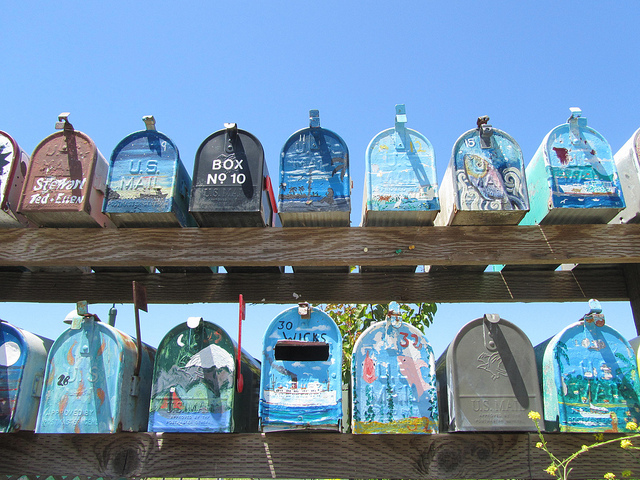 A shot of a row of different mailboxes.